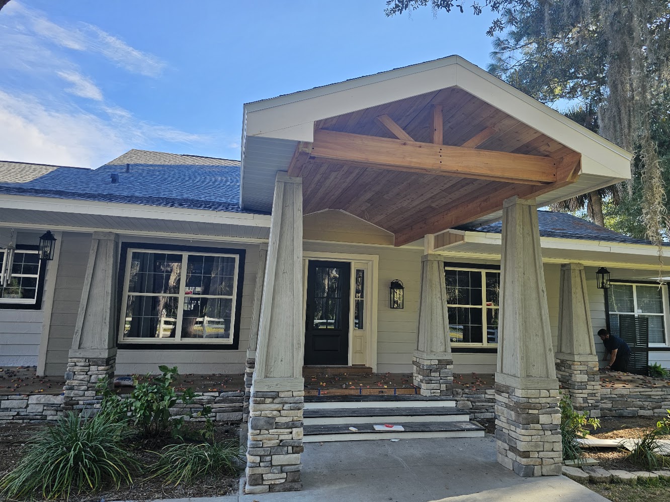 Covered entry project with timber ceiling and stone columns