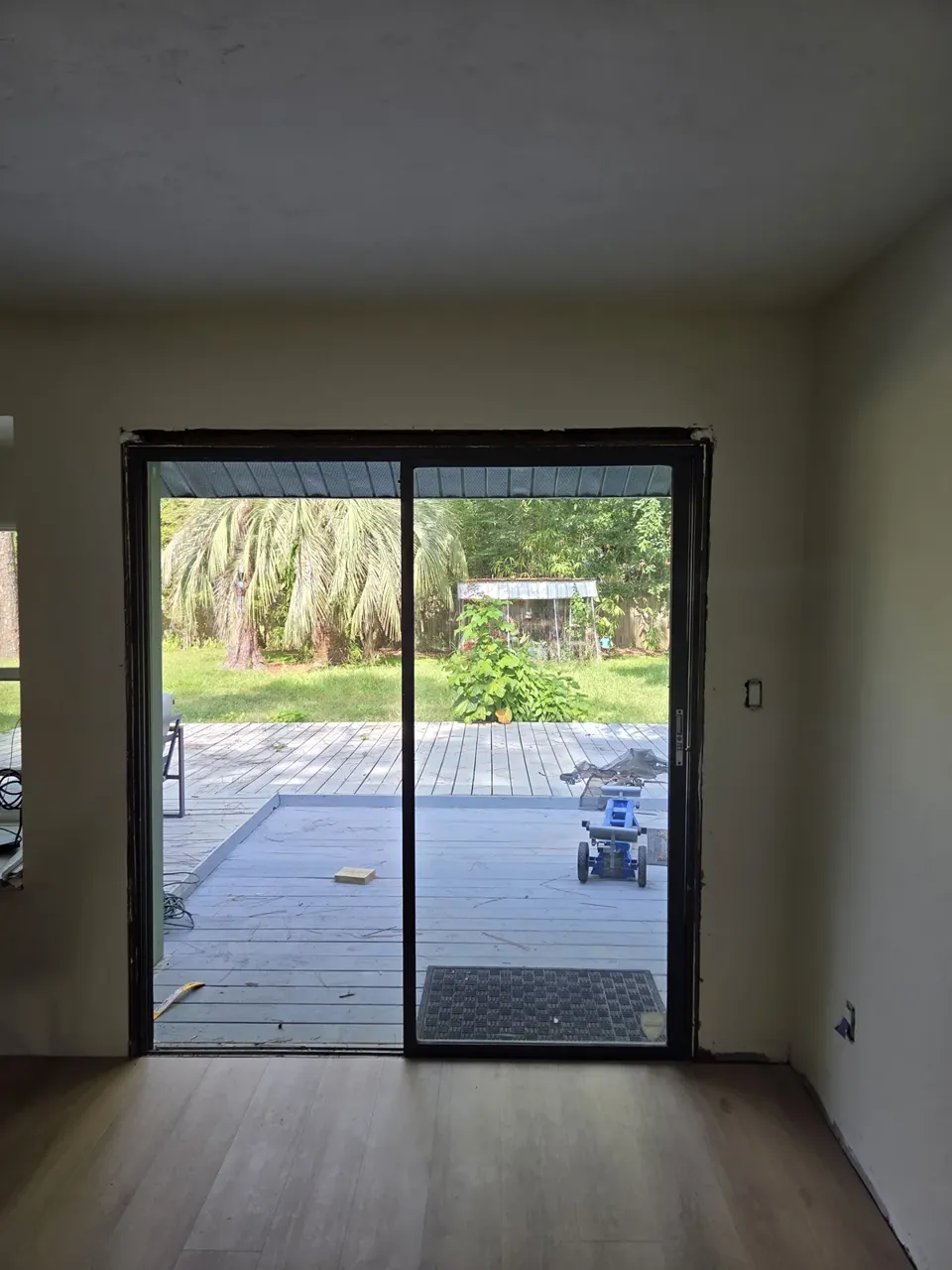 Old aluminum sliding glass door seen from inside