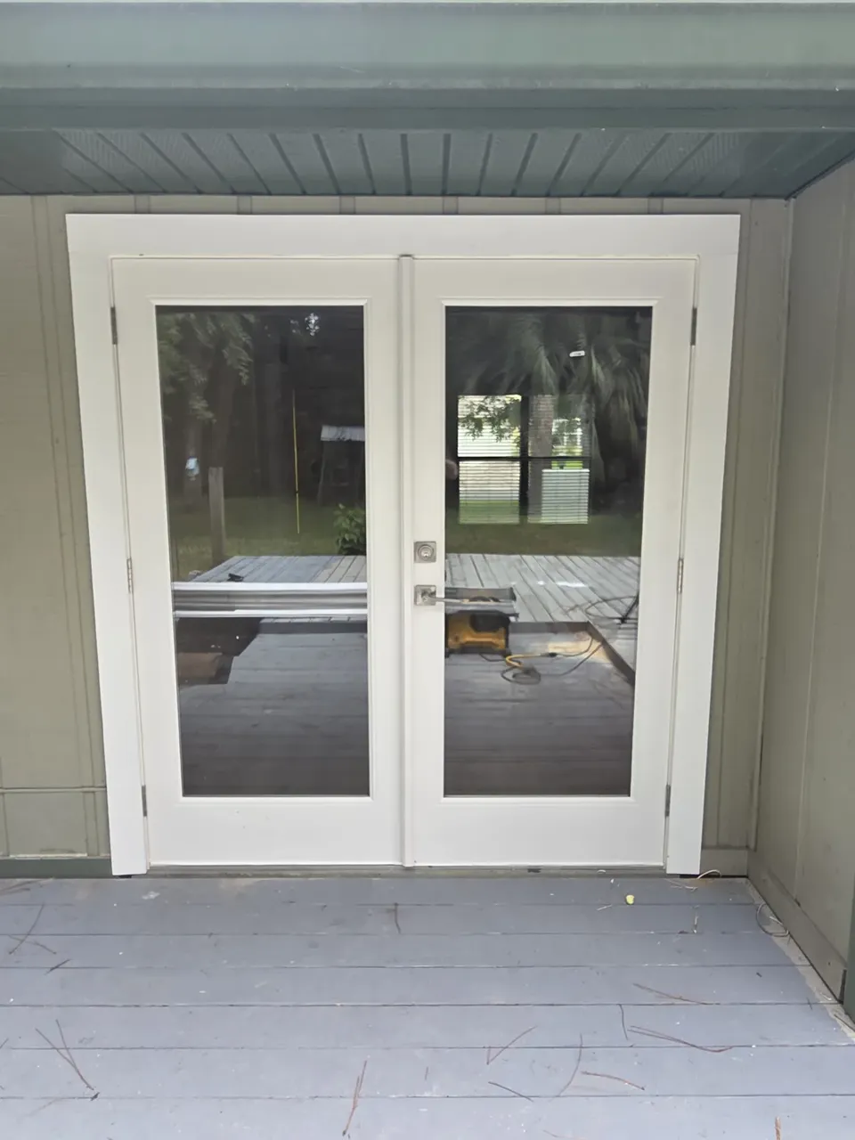 White French doors on the back of the house, from the deck