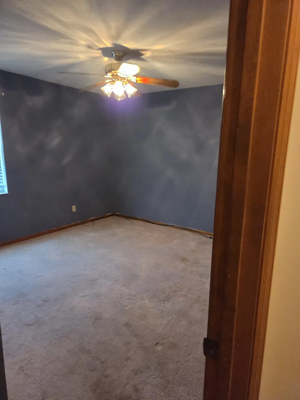 Ocala bedroom before: worn carpet and dated paint