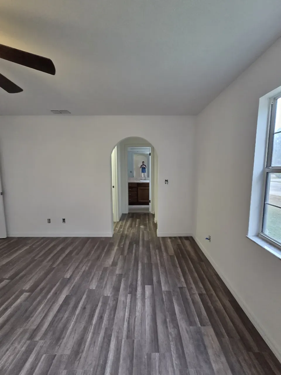 Ocala arched hallway after: grey LVP plank flooring and fresh white paint