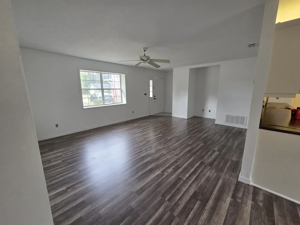 Ocala living room after: grey LVP plank flooring and fresh white paint