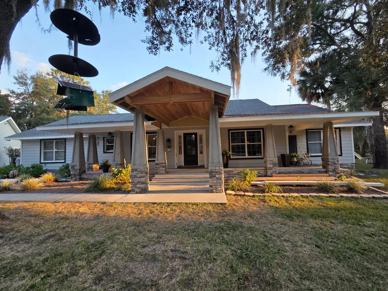 Finished craftsman front porch in Crystal River with cedar gable and stone columns