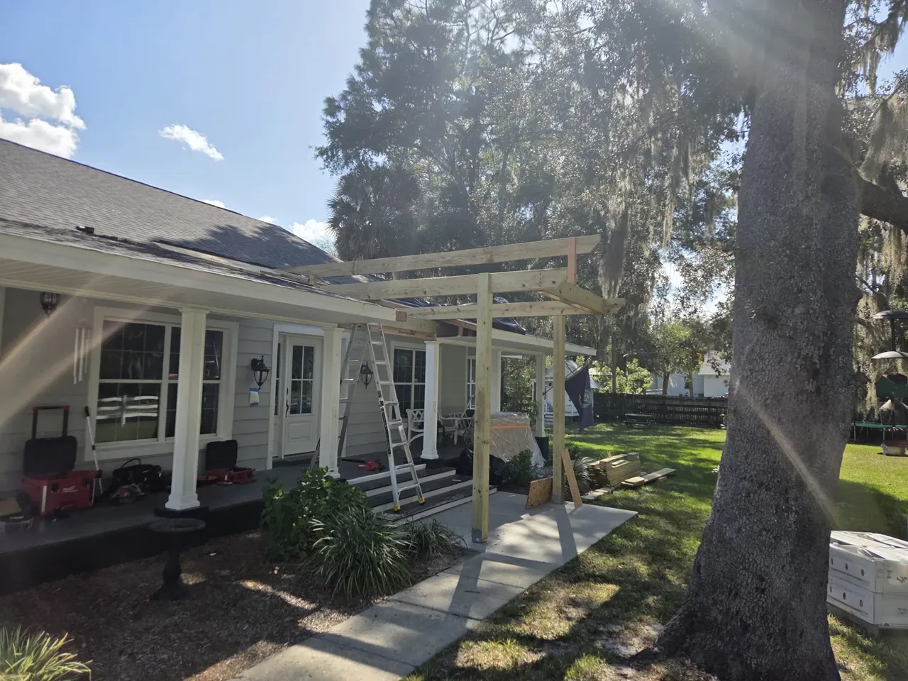 The same house before the porch build, with the first posts going up