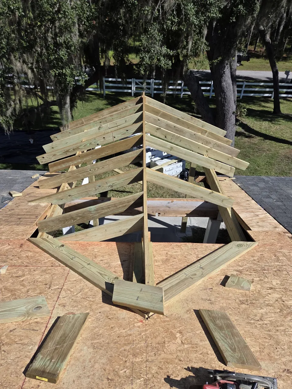 Gable rafters framed on the ground before lifting